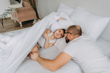 Father with a baby under the covers