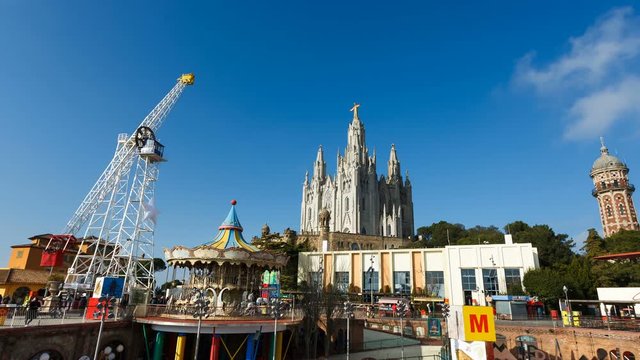 Amusement park on Tibidabo hill on the background of Sacred Heart of Jesus Church