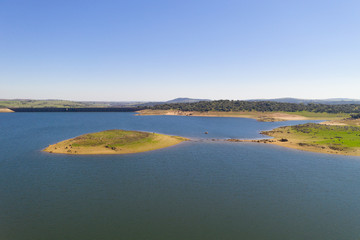 Dam lake reservoir drone aerial view of Barragem do Caia Dam olive trees landscape in Alentejo, Portugal