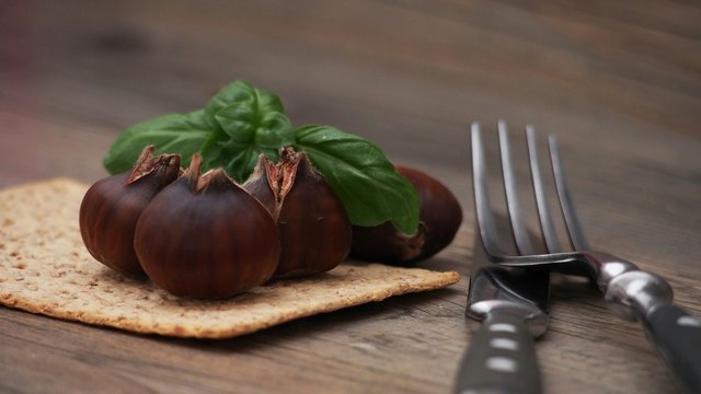 Close-up Of Fig With Cookie And Cutlery On Table