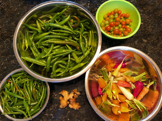 Bowls with freshly picked vegetables in the greenhouse