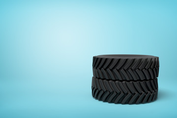 3d rendering of two black wheel tyres stocked on blue background