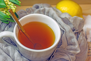 Cup of black tea with a spoon close-up, top view