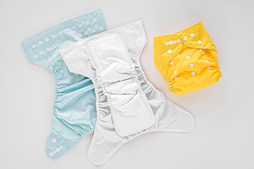 Reusable cloth baby diapers. Eco friendly cloth nappies on a white background. Sustainable...