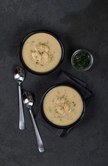 Bean soup-puree with dill, parsley in a bowl on a dark background top view