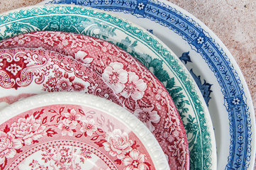 Antique porcelain dishes on concrete background.