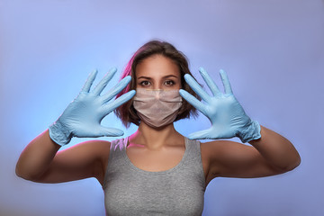 Covid-19 Pandemic Coronavirus Girl with protective mask on face and medical gloves. Woman isolated on the light background in studio