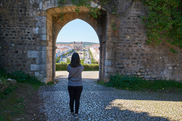 Fototapeta na wymiar Woman girl traveler photographing Gate Entrance of Vila Vicosa castle in Alentejo, Portugal