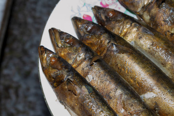 Smoked fresh fish mackerel lies hot on a ceramic plate