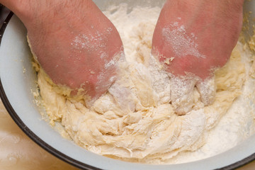 Cooking dough in a white plastic bowl at home