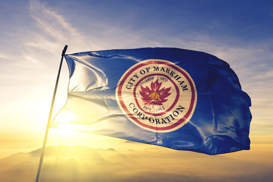 Markham of Ontario of Canada flag waving on the top sunrise mist fog