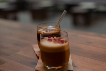 A glass of hot and cold coffee in a cafe.  Cold brew and cappuccino coffee.  