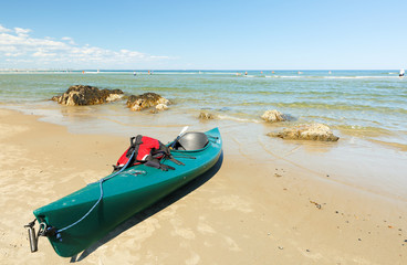 A Green Kayak Docking on the Ogunquit Beach, Maine. Ogunquit was named by the Abenaki tribe, because the word means "beautiful place by the sea"