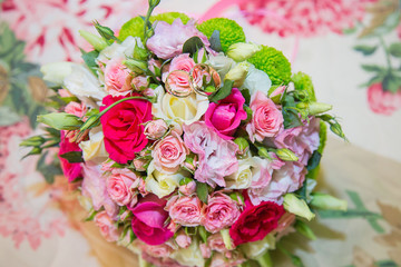 beautiful bride’s wedding bouquet lies and on it lie wedding gold rings for husband and wife