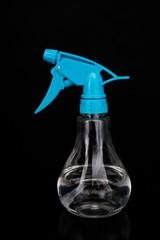 A small sprinkler for home flowers with a transparent container. Vegetable care accessories.