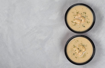 Vegan bean soup-puree with dill, parsley in a bowl on a light background top view