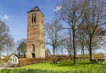 Fototapeta na wymiar Historic church tower in small village Nijemirdum, Netherlands