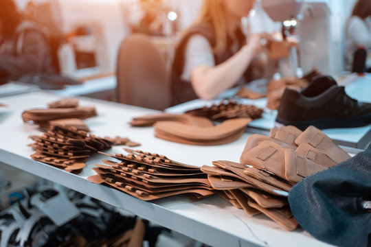 woman work with sewing machinery on shoe factory
