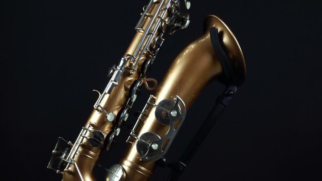 Wind Instrument Saxophone On A Black Background.