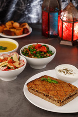Ramadan. Arabic family dinner. Traditional arabic food. Close-up view. Eid Mubarak. Table with sharing plates food. Ramadan decoration. Lebanese cuisine. Starters, hummus, baklava, dates. Muslim