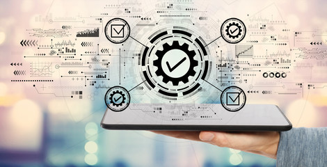 Quality control approval with man holding a tablet computer