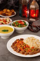 Ramadan. Arabic family dinner. Traditional arabic food. Close-up view. Eid Mubarak. Table with sharing plates food. Ramadan decoration. Lebanese cuisine. Starters, hummus, baklava, dates. Muslim