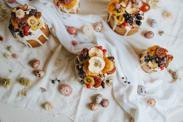 Easter cake decorated with glaze, dry fruits, sprinkles, dry flowers. Easter quail eggs in pastel shades