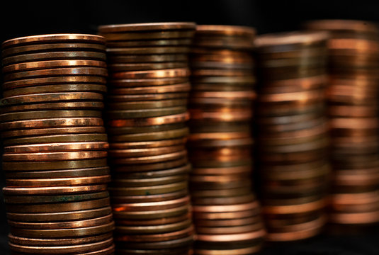 Stacks of pennies on a black background.