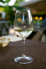 A glass of white wine on the coffee table