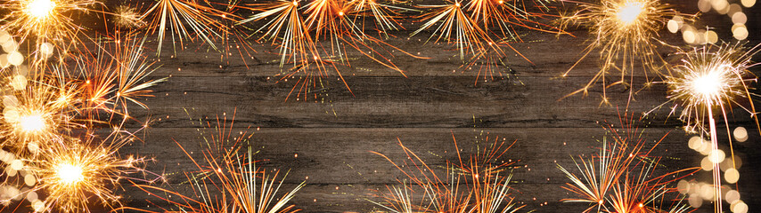 Silvester background panorama long - Firework on rustic brown wooden texture with space for text	
