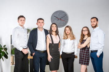 Fototapeta premium Smiling employees standing looking camera making team picture in office together. Business People Team. Successful company with happy workers. People Meeting Communication Corporate Teamwork Concept