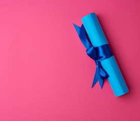 roll of blue paper tied with a silk blue ribbon - Powered by Adobe