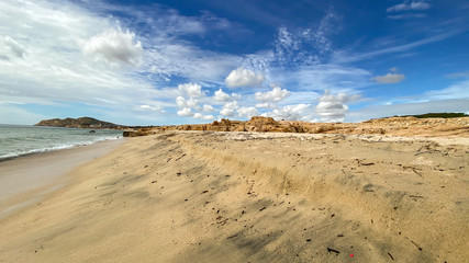 Sand beach with white clouds in blue sky
