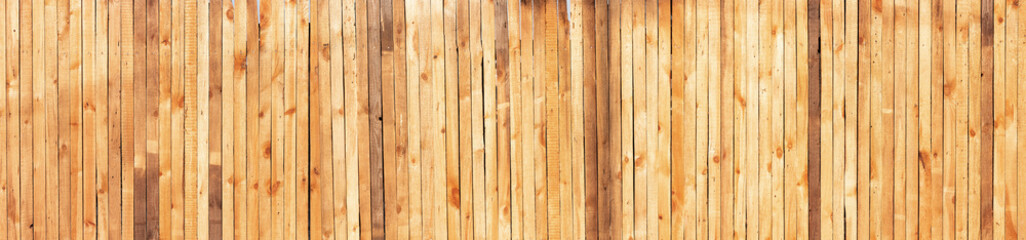 Wide wooden wall with vertical boards texture.