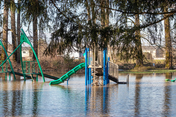 a flooded public park with a playground
