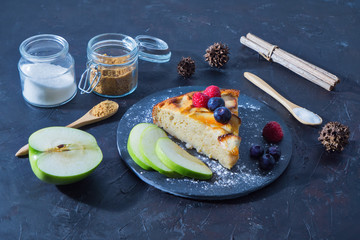 slice of apple pie on a slate plate with a dark rustic surface, top view, dessert concept