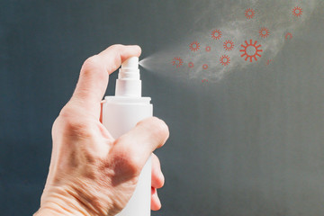 A man sprays antiseptic from a can