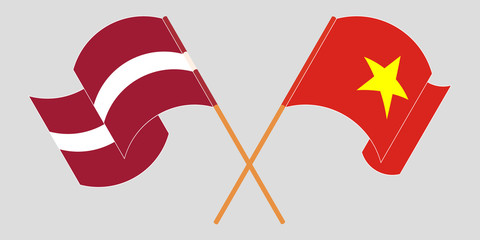 Crossed and waving flags of Latvia and Vietnam