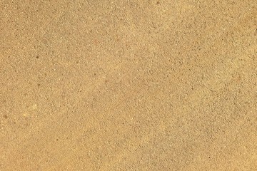 Fototapeta na wymiar Sandy surface. Yellow-brown background. Textured, natural surface.
