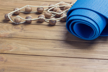 Blue training mat and massager with wooden castors.