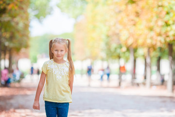 Adorable fashion little girl outdoors in the Tuileries Gardens, Paris