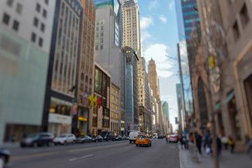 Fototapeta na wymiar Street view of light traffic in a New York City street. Shot with manual Tilt Shift lens for selective focus effect.