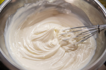 Whipped cream white in bowl, top view