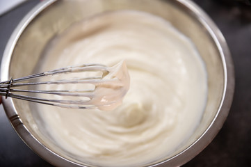 Whipped cream white in bowl, top view