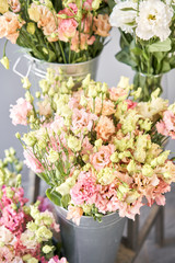 Bunches of flowers different varieties eustoma in vases. Lovely Vintage background with flowers. Wallpapers