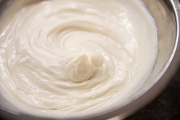 Whipped cream white in bowl, top view