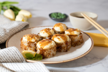 Top view on the plate of baked rolls with sauce