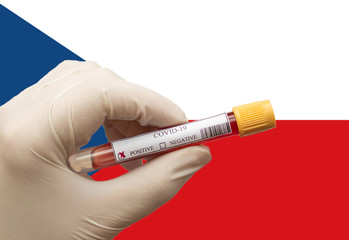 COVID-19 Pandemic Coronavirus concept ; Close-up of a Positive COVID-19 blood test sample tube with  Flag of Czech Republic at background. Blood testing for diagnosis new Corona virus infection.