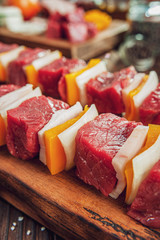 Raw meat stick with ingredients in close-up - Brazilian espetinho de carne