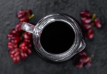 Portion of healthy Red Grape Juice (selective focus; close-up shot)